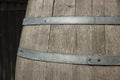 Germany. Heidelberg Castle. Fragment of an old wooden vine barrel with an metall hoop on a dark background. Wooden barrel with