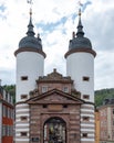 Germany, Heidelberg city. Old Bridge with large arched Gate between two white Tower. Vertical