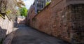 Germany, Heidelberg city. Way to the castle between brick wall and stonewall on narrow street