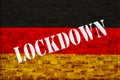 Germany Lockdown for Coronavirus Outbreak quarantine. Germany flag on a brick wall with the lockdown inscription.