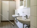 GERMANY - MAY 2016: Interior of an old bathroom. White washbasins, doors.