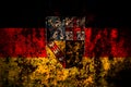 Germany, Saarland flag on grunge metal background texture with scratches and cracks