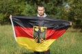 Germany silk flag in man`s hands Royalty Free Stock Photo