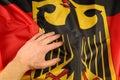 Germany silk and hand flag Royalty Free Stock Photo