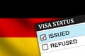 Germany visa issue with red tick in the box, waving flag in the backdrop Royalty Free Stock Photo