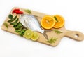 Gerres Fish Gerres Filamentosus , Whipfin silver biddy Fish , Decorated with curry Leaves and Tomato on a Wooden pad,White Royalty Free Stock Photo