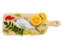 Gerres Fish Gerres Filamentosus , Whipfin silver biddy Fish , Decorated with curry Leaves and Tomato on a Wooden pad,White Royalty Free Stock Photo