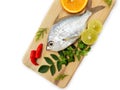 Gerres Fish Gerres Filamentosus , Whipfin silver biddy Fish , Decorated with curry Leaves and Tomato on a Wooden pad,White Royalty Free Stock Photo