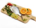 Gerres Fish Gerres Filamentosus , Whipfin silver biddy Fish , Decorated with curry Leaves and Tomato on a Wooden pad,White Royalty Free Stock Photo