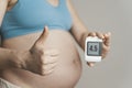 Gestational diabetes in pregnancy. Pregnant woman check sugar level with a glucometer. Glucose intolerance, diabetic