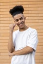 Portrait of a handsome African-American guy with a ponytail dressed in a white T-shirt Royalty Free Stock Photo