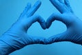 Hands in blue medical gloves shows a heart Royalty Free Stock Photo