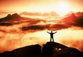 Gesture of triumph. Happy hiker in black. Tall man on the peak of sandstone rock in national park Saxony Switzerland above valley Royalty Free Stock Photo