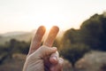 Gesture of victory or hand of peace in a sunset