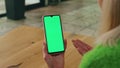 Gesturing woman holding greenscreen phone. Closeup director hand gesticulate