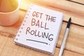 Get the ball rolling, text words typography written with paper, life and business motivational inspirational