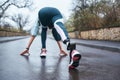 Get better everyday Back view of disabled athlete woman in sportwear with prosthetic leg getting ready to run outdoor Royalty Free Stock Photo