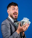 Get cash easy and quickly. Cash transaction business. Man happy winner rich hold pile of dollar banknotes blue Royalty Free Stock Photo