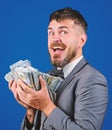 Get cash easy and quickly. Cash transaction business. Man happy winner rich hold pile of dollar banknotes blue Royalty Free Stock Photo