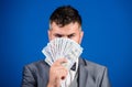 Get cash money easy and quickly. Smell of money. Easy cash loans. Man formal suit hold pile of dollar banknotes blue Royalty Free Stock Photo