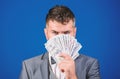 Get cash money easy and quickly. Smell of money. Easy cash loans. Man formal suit hold pile of dollar banknotes blue Royalty Free Stock Photo