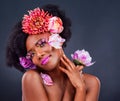 Get creative with your look. Studio shot of a beautiful young woman posing with flowers in her hair. Royalty Free Stock Photo