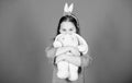 Get in easter spirit. Happy childhood. Bunny ears accessory. Lovely playful bunny child hugs soft toy. Have blessed