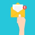 Get email concept. Hand holding envelope with notification.