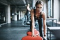 Get fit for the health of it. a young woman working out with weights in a gym. Royalty Free Stock Photo