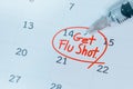 Get Flu shot text on calendar and syringe,influenza background concept