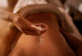 Get a massage for the health of it. a young woman enjoying a salt exfoliation treatment at a spa. Royalty Free Stock Photo