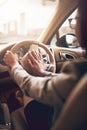 Get a move on. an unidentifiable businesswoman pressing the hooter while driving a car.