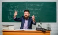 Get out of class. School principal threatening with punishment. Teacher strict serious bearded man chalkboard background