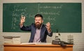 Get out of class. School principal threatening with punishment. Teacher strict serious bearded man chalkboard background