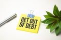 GET OUT OF DEBT text on paper with calculator, notepad, coffee ,pen with graph Royalty Free Stock Photo