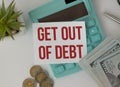 Get Out Of Debt text on paper with calculator, notepad, pen with money Royalty Free Stock Photo