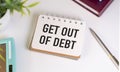 GET OUT OF DEBT text on paper with calculator, notepad, pen with money Royalty Free Stock Photo