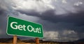 Get Out Green Road Sign and Stormy Clouds Royalty Free Stock Photo