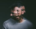 Get out of my head. Studio shot of a young man experiencing mental anguish and screaming against a black background. Royalty Free Stock Photo