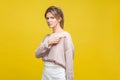 Get out! Portrait of angry young bossy woman with fair hair in casual beige blouse, isolated on yellow background Royalty Free Stock Photo