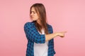 Get out! Portrait of resentful offended girl in checkered shirt frowning from anger and pointing way