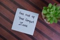 Get Out of Your Comfort Zone write on sticky notes isolated on Wooden Table Royalty Free Stock Photo