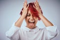 Get out of your own head. Studio shot of an attractive young woman screaming against a gray background. Royalty Free Stock Photo