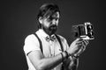 get a pose. elegant male hold retro camera. handsome hipster making vintage photo. mature journalist use old technology