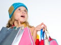 Get promo code. Amazing sale and discount. Shopping on black friday. Girl amazed face knitted hat hold shopping bags