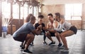 Get ready for strong glutes. a group of young people doing squats together during their workout in a gym. Royalty Free Stock Photo