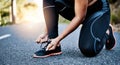 Get ready to run your own life. an unrecognizable woman tying her shoelaces.