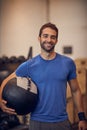 Get ready to transform your body. Cropped portrait of a handsome young man working out with a medicine ball in the gym. Royalty Free Stock Photo