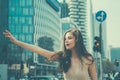 Get a ride. Woman hailing taxi. Woman catch taxicar on city street. Travel, tourism and people concept. Gesture for