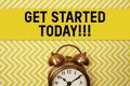 Get Started Today text with alarm clock on yellow background Royalty Free Stock Photo